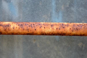 H2S dissolves in water to create a weak acid that can corrode metal pipes